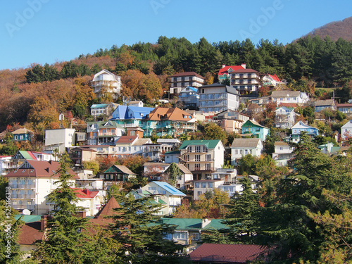 A small town on the mountain slopes, a landscape against the background of mountain peaks. The concept of travel, recreational tourism.