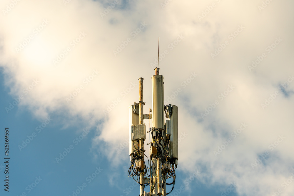 New GSM antennas on a high tower against a blue sky for transmitting a 5g signal are dangerous to health. Radiation pollution of the environment through cell towers. The threat of extinction New GSM antennas on a high tower against a blue sky for transmitting a 5g signal are dangerous to health. Radiation pollution of the environment through cell towers. The threat of extinction