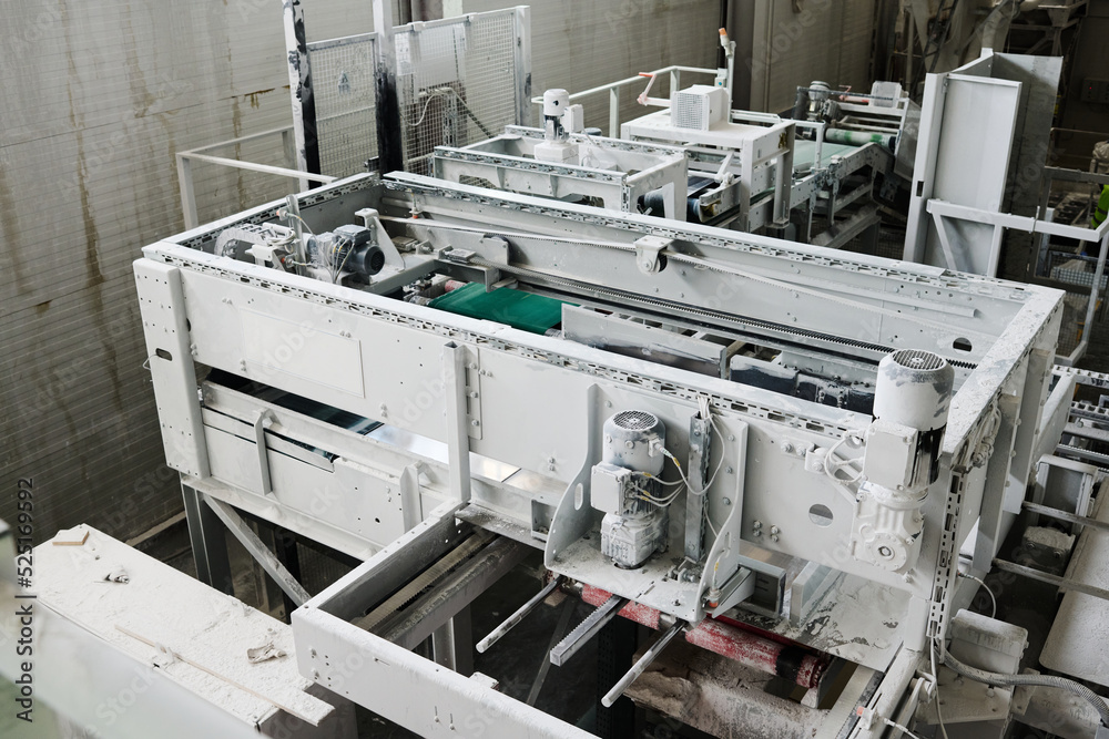 Part of spacious workshop or plant with huge machine or other technical equipment prepared for industrial production or processing Part of spacious workshop or plant with huge machine or other technical equipment prepared for industrial production or processing
