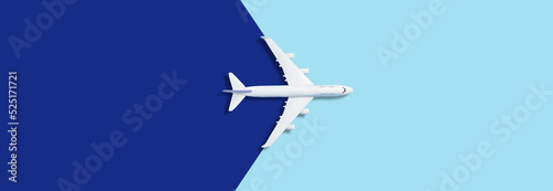 Flat lay design of travel concept with plane on blue background with copy space