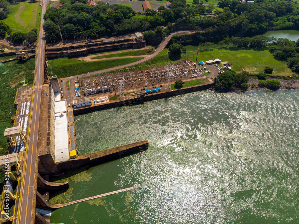 Aerial view of Dam at reservoir with flowing water, hydroelectricity power station.