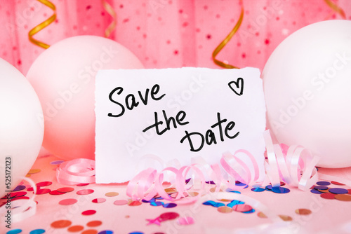 Save the date card with text and pink background with air balloons and colorful decorations © justesfir