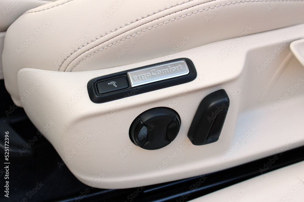 Car seat adjustment. Buttons for adjusting seat position. Car interior detail. White leather interior of the luxury modern car. Car seat adjustment. Buttons for adjusting seat position. Car interior detail. White leather interior of the luxury modern car.