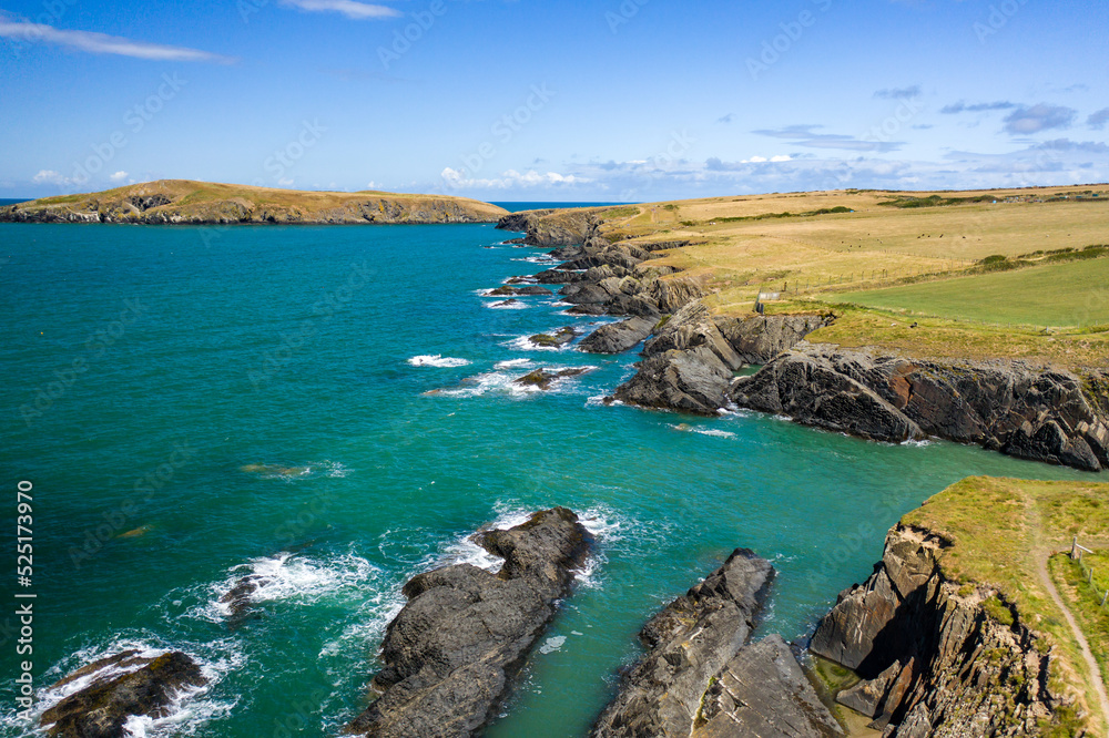 Low altitude aerial view of the rugged Welsh coastline in Pembrokeshire (Gwbert)