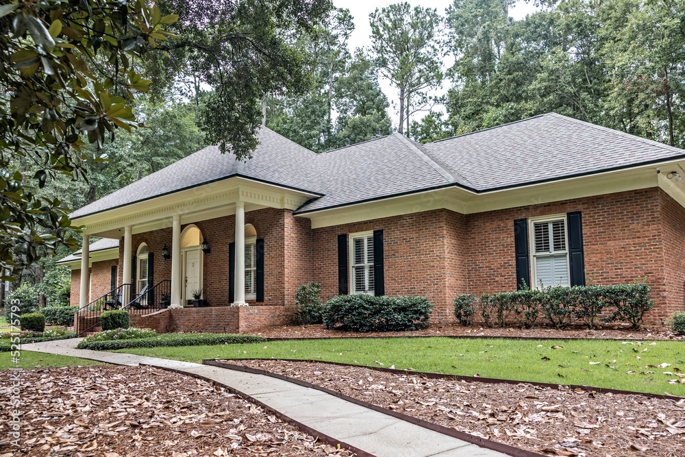 A front side view of an updated spacious red brick ranch traditional