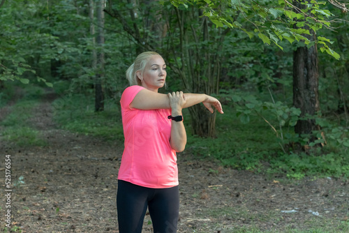 a young woman before jogging in the forest does a warm-up Does sports Leads a healthy lifestyle