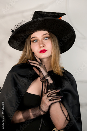 Vertcial banner of beautiful girl dressed as a witch. Halloween party concept photo