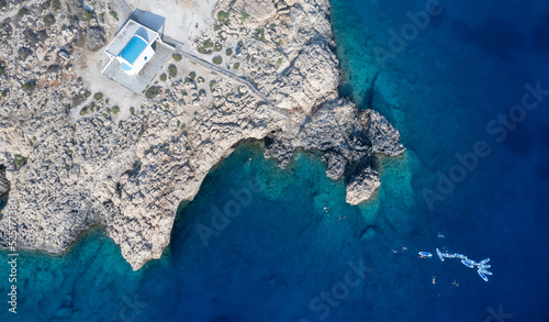 Drone aerial photograph of Cape Greco peninsula with Agioi Anargyroi  church on the rocks. Turquoise ocean water photo