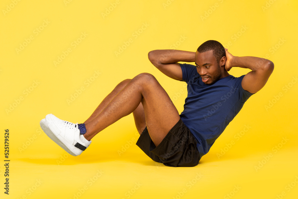 Black Fitness Guy Doing Sit Ups Exercise On Yellow Background - obrazy, fototapety, plakaty 