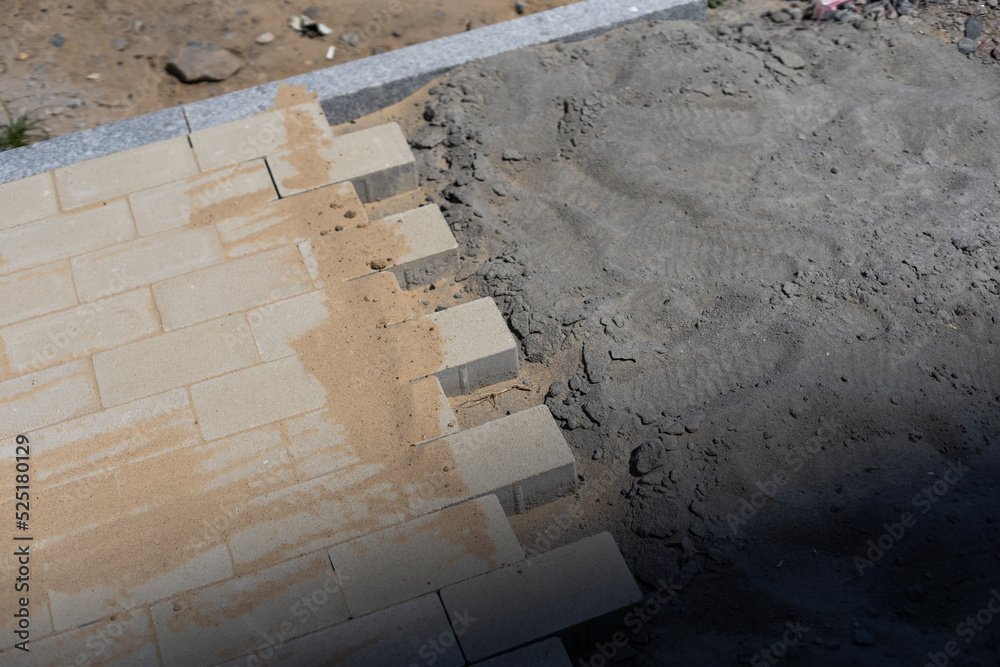 Stone blocks laying is on sand base. Sidewalk device. Stone blocks laying is on sand base. Sidewalk device.