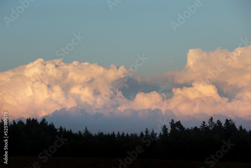 sunset in the mountains with big cumulus clouds