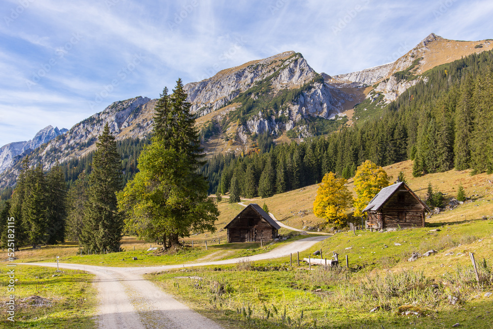 Idyllic mountain landscape with cabins and autumn colors. Location is the Gesäuse national park in Styria, Austria