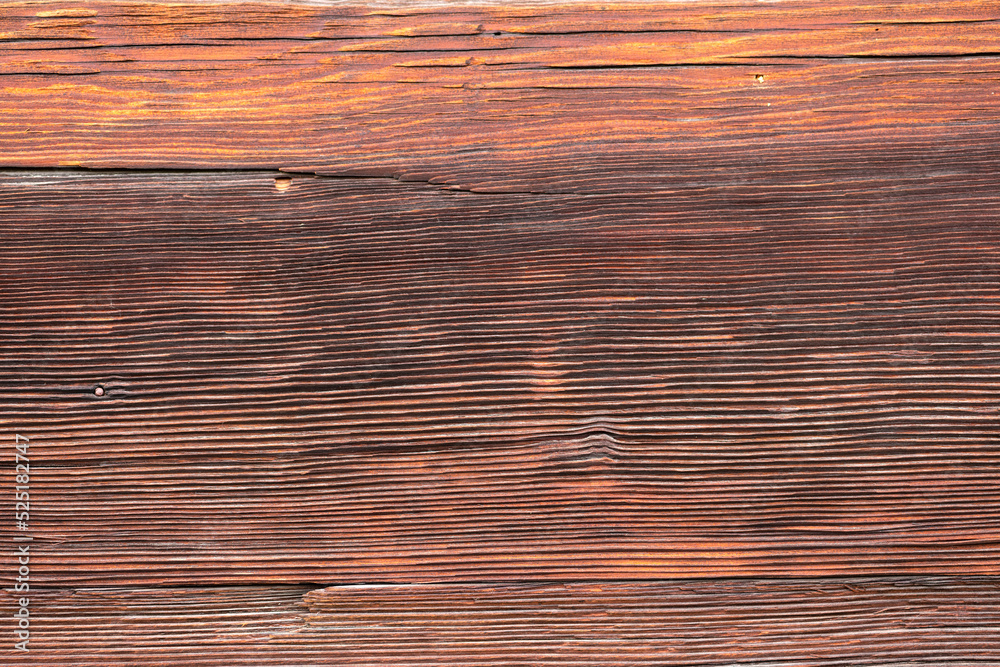Macro shot of an ancient weathered dark brown cracked wood beam surface with nice rough grain texture. Macro shot of an ancient weathered dark brown cracked wood beam surface with nice rough grain texture.