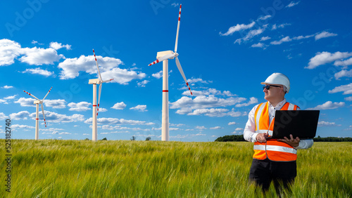 Wind energy. Man in hardhat...