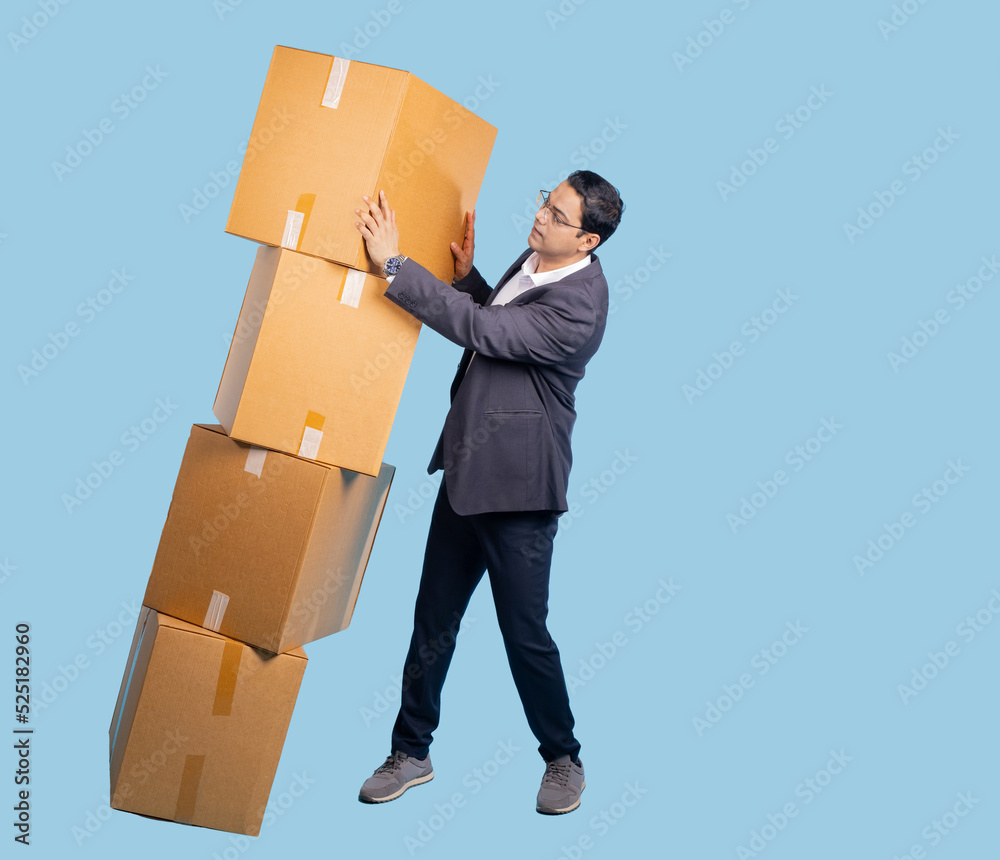 Man catches boxes. Indian entrepreneur. Guy with boxes in full growth. Man in business suit. Concept of problems with order processing. Entrepreneur with boxes on turquoise background Man catches boxes. Indian entrepreneur. Guy with boxes in full growth. Man in business suit. Concept of problems with order processing. Entrepreneur with boxes on turquoise background