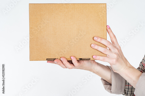 Cardboard box. Woman shows ...