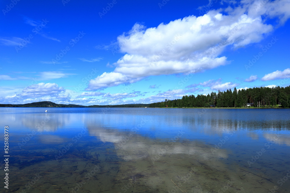 Cloud reflection in a calm sea. Summer day. Jämtland, Sweden, Scandinavia, Europe, 2022.