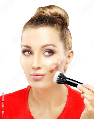 Applying Make-up. Woman with a brush for make-up.Shades of makeup powder on white background.