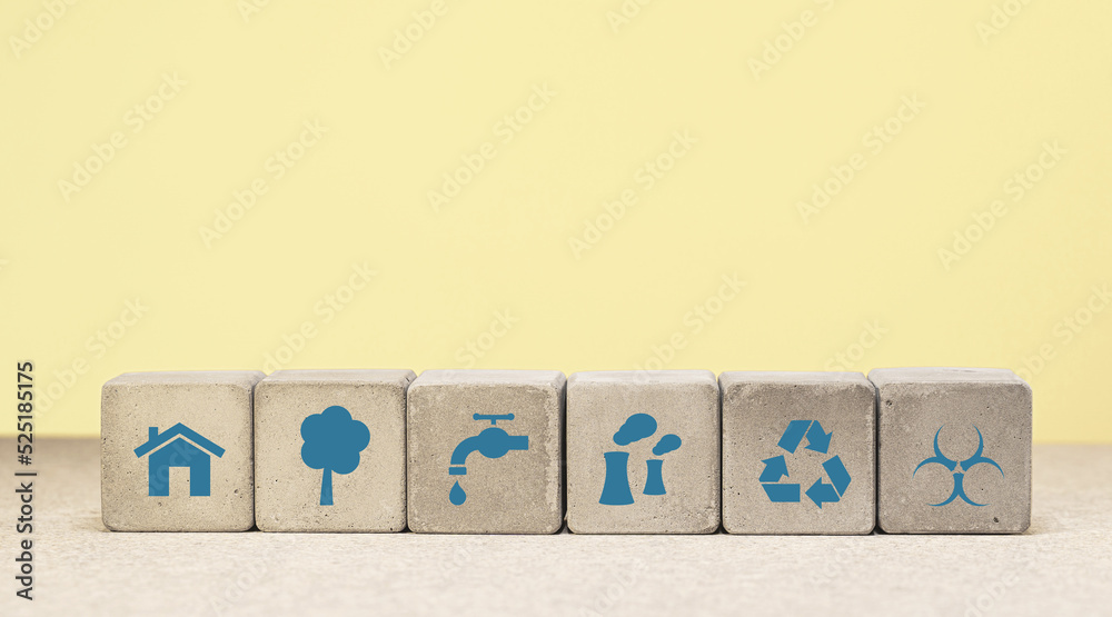 The concept of environmental protection. concrete cube with green economy icons, energy sources. copy space. green energy The concept of environmental protection. concrete cube with green economy icons, energy sources. copy space. green energy