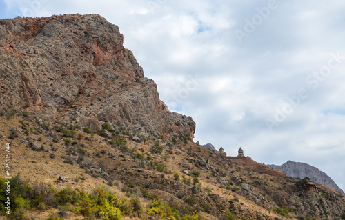 Road through canyon with admire the Noravank Monastery as it appears high on the cliff, landmark of Armenia