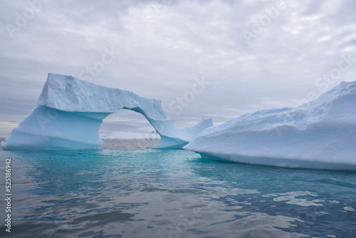 iceberg with natural arch formation in Antarctica © Chelsea
