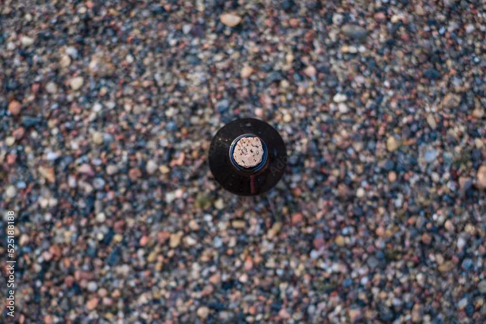 Essential oil bottle on a beach with rocks. Little brown medicine bottle in nature background. Organic CBD hemp oil. Top view. Essential oil bottle on a beach with rocks. Little brown medicine bottle in nature background. Organic CBD hemp oil. Top view.