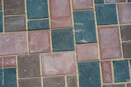 Paving slabs of different colors and shapes.Texture of different colored patterned paving slabs . Modern road surface.