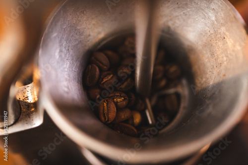 barista holding hand grinde...