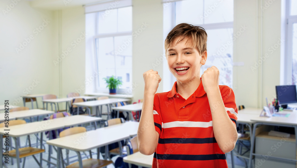 education, school and people concept - portrait of happy smiling boy in red polo t-shirt celebrating success over classroom background education, school and people concept - portrait of happy smiling boy in red polo t-shirt celebrating success over classroom background
