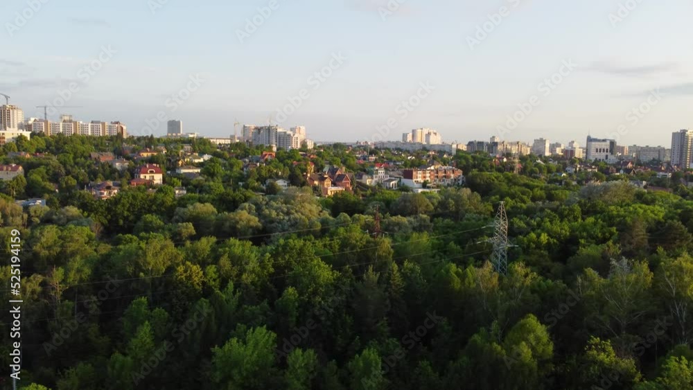 Aerial evening view from fpv drone on green Kharkiv city center district near recreation park Sarzhyn Yar. Residential area in sunset light Aerial evening view from fpv drone on green Kharkiv city center district near recreation park Sarzhyn Yar. Residential area in sunset light