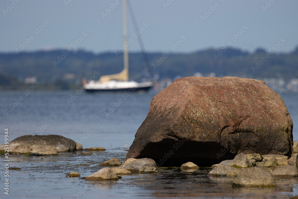 sailboat on the sea, rocky sea shore on the island of Rügen in Germany