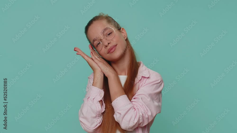 Tired overworked teenager young girl yawning, sleepy inattentive feeling somnolent lazy bored gaping suffering from lack of sleep. Bored student child kid isolated on blue studio background indoors Tired overworked teenager young girl yawning, sleepy inattentive feeling somnolent lazy bored gaping suffering from lack of sleep. Bored student child kid isolated on blue studio background indoors