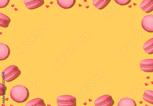 Macaroons. Backdrop with copy space. French cookies and heart shaped candies in top view