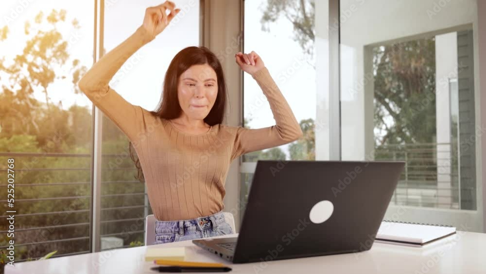 Woman working on her laptop while working from home. Woman working on her laptop while working from home.