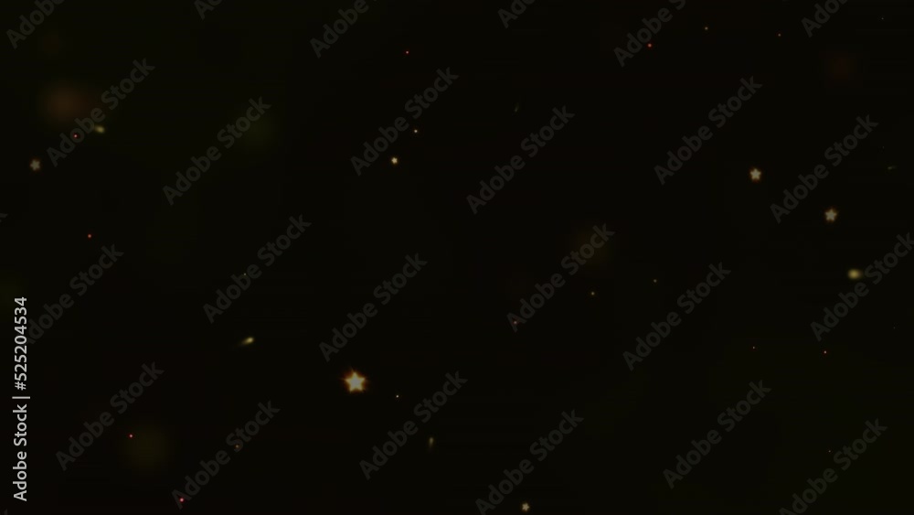 An explosion of bright yellow particles in a slow motion on a black background.