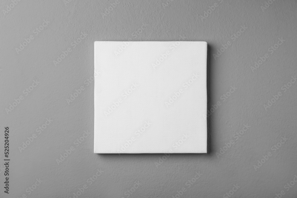 Blank canvas on grey wall. Space for design Blank canvas on grey wall. Space for design
