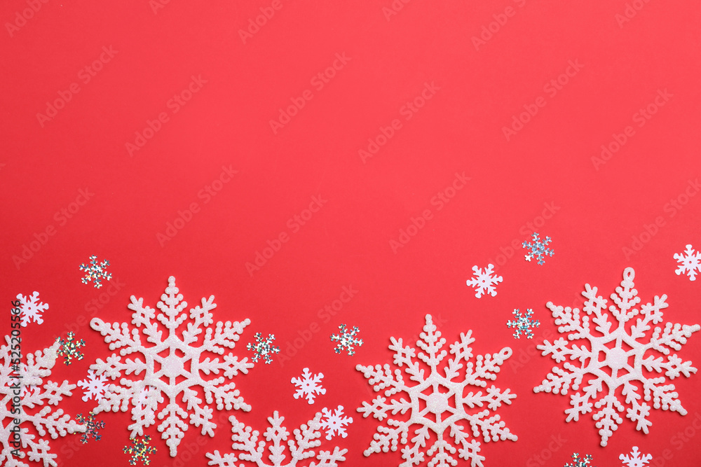 Beautiful decorative snowflakes on red background, flat lay. Space for text Beautiful decorative snowflakes on red background, flat lay. Space for text