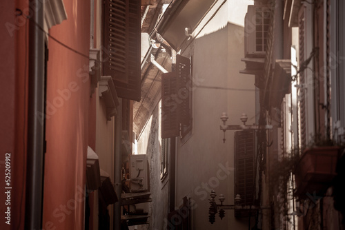 Selective blur on the wooden shutters of houses in Typical mediterranean old narrow street with southern european architecture, with buildings in old town of piran or Pirano one of cities of Istria