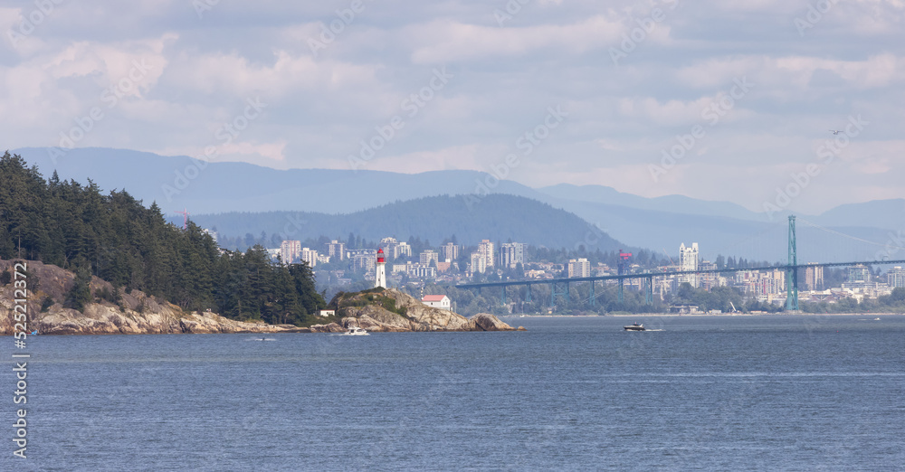 Lighthouse Park, Modern city in background during sunny summer day. West Vancouver, British Columbia, Canada. Lighthouse Park, Modern city in background during sunny summer day. West Vancouver, British Columbia, Canada.
