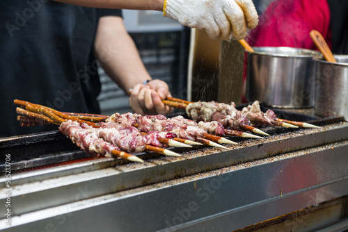 Marinated shashlik preparing on a barbecue grill over charcoal. Shashlyk (skewered meat) was originally made of lamb.