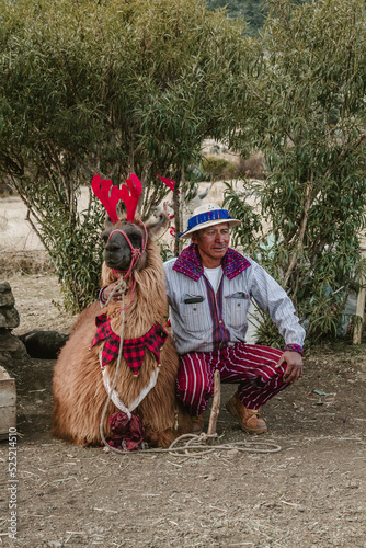 indigenous in the middle of the mountains of guatemala with llama and traditional costume photo