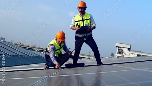 Wallpaper Mural Service Engineers inspecting factory roof solar installations in the morning Silhouette technicians inspect and repair solar cells on factory roofs. Torontodigital.ca