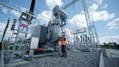 Electrical engineers inspect the electrical systems at the equipment control cabinet