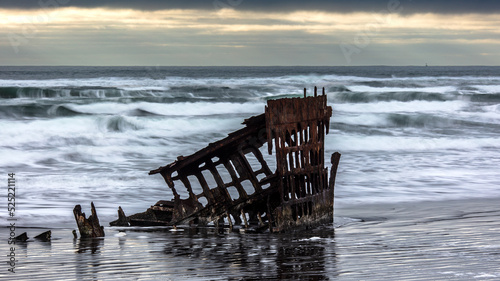 Peter Iredale Shipwreck at Dusk on Pacific Ocean Beach in Fort Stevens State Park Near Astoria, Oregon photo