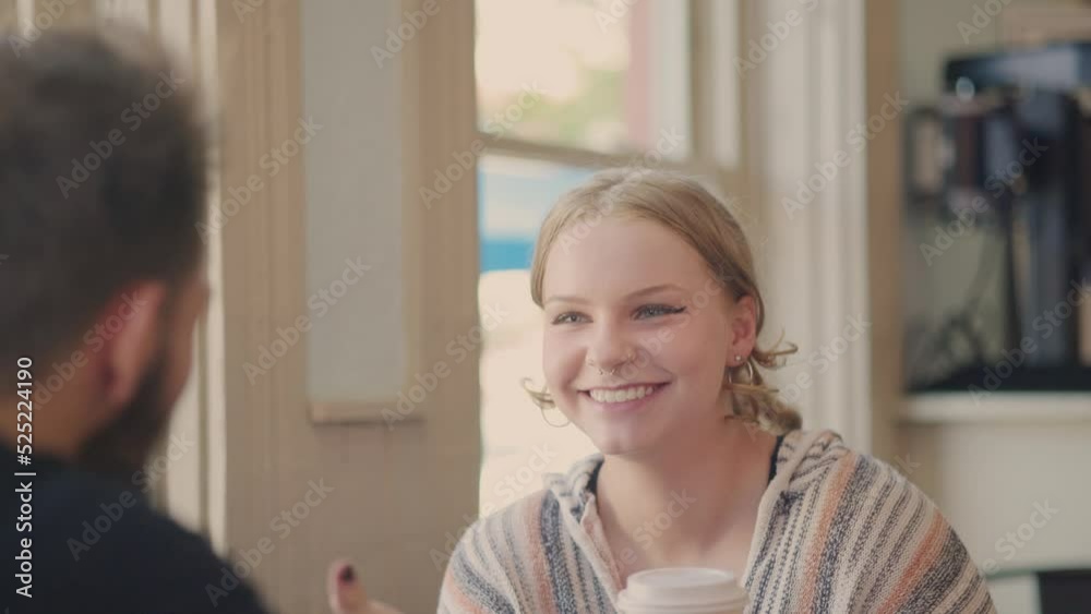 Girl talking in positive conversation with a guy in a bright cafe. Slow motion. Girl talking in positive conversation with a guy in a bright cafe. Slow motion.