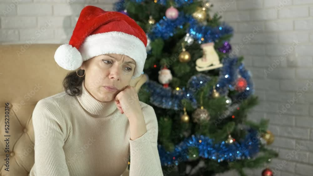 Woman unhappy Christmas preparation. A woman with sad mood prepare for Christmas eve in the living room. Woman unhappy Christmas preparation. A woman with sad mood prepare for Christmas eve in the living room.
