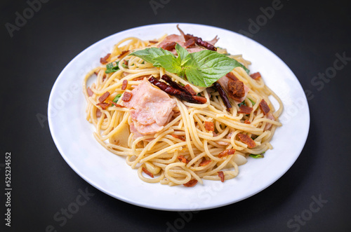spagetti ham with bacon spicy isolated on black background