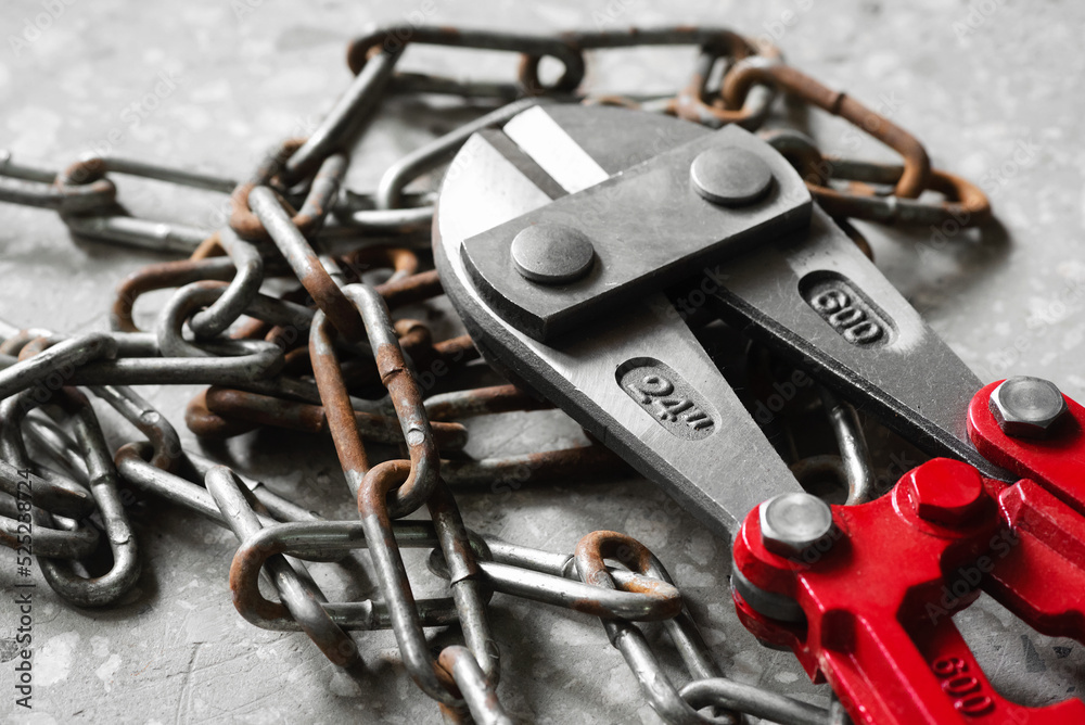 Fototapeta premium Bolt cutters rebar shears and iron chain background.