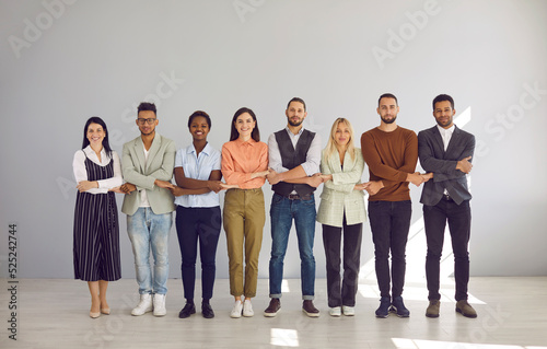 Portrait of diverse multiracial employees hold hands show team unity and integrity in office. Smiling multiethnic people feel united at workplace, involved in teambuilding. Business, teamwork. photo