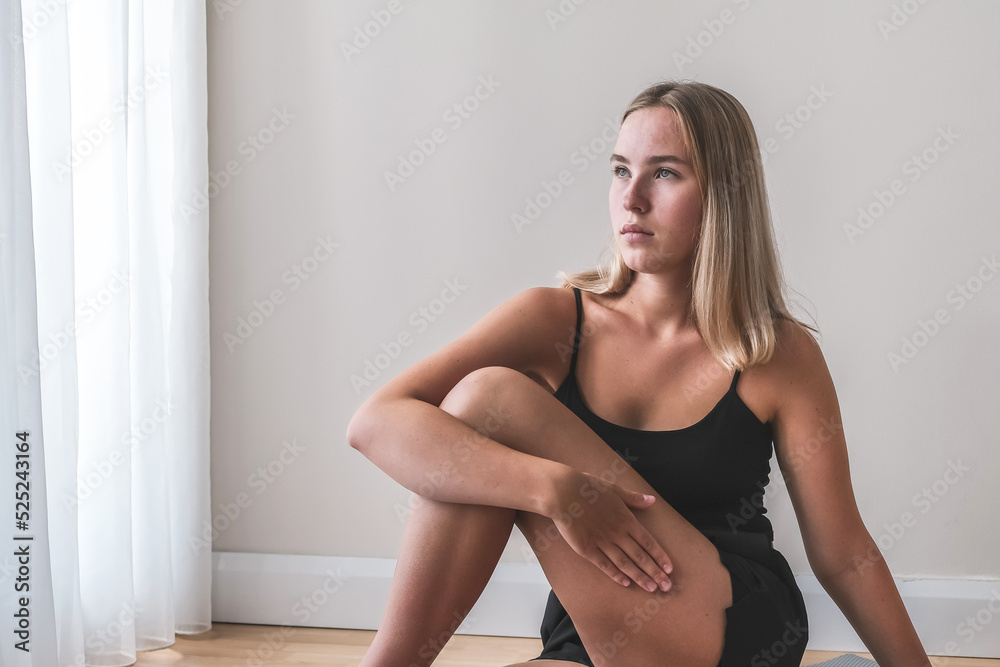 Fototapeta premium Sports fit home.Girl goes sports, fitness, yoga, meditative breathing practices.Meditation, relaxation,mental health. Active lifestyle, personal care, health.Wellness,workout,physical health.Smart fit